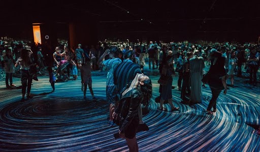  People mesmerized by an installation