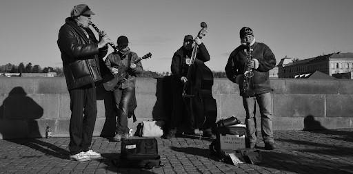 street performers, buskers playing music in public, architecture competitions, word of the day, design for music, street performances, latin transfigūrāre, architecture challenge, cultural architecture  